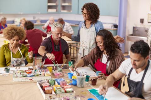 Group of adults learning to paint together.
