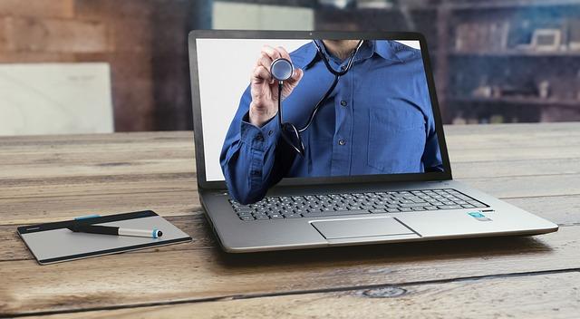 A laptop screen with the torso of a person wearing a stethoscope and holding it up